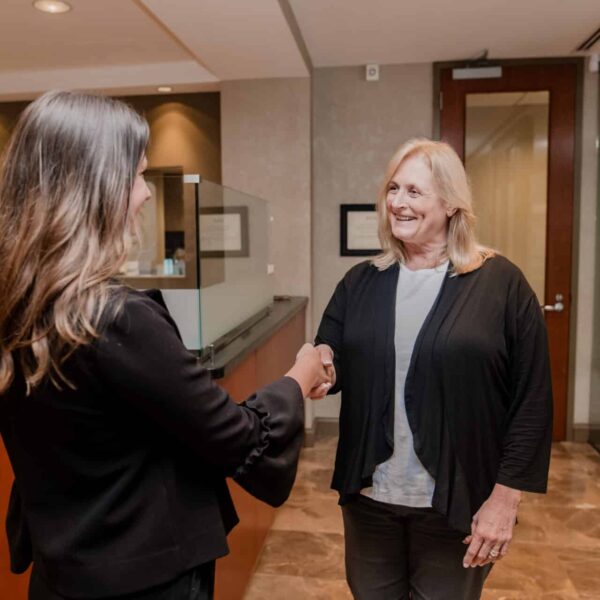 two women shaking hands