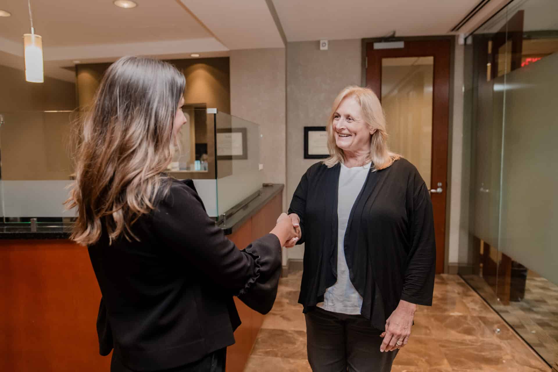 two women shaking hands