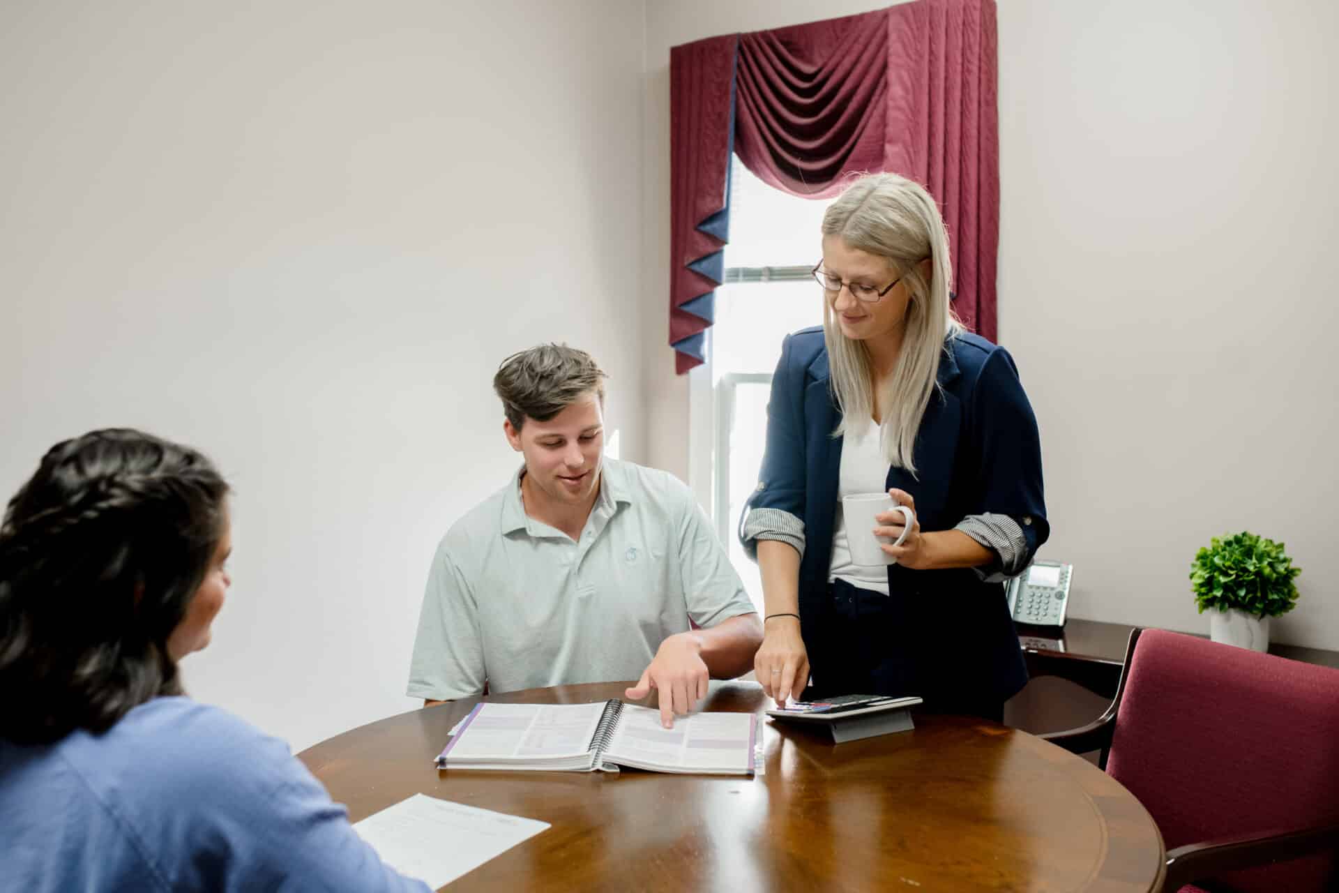 woman representative pointing out something on a sheet to a male client