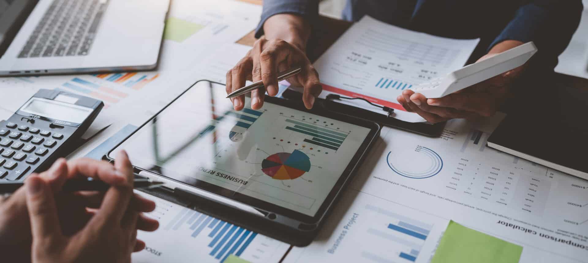 Business idea. Business people talking And calculations about charts and graphs showing the growth of investment results Of successful teamwork