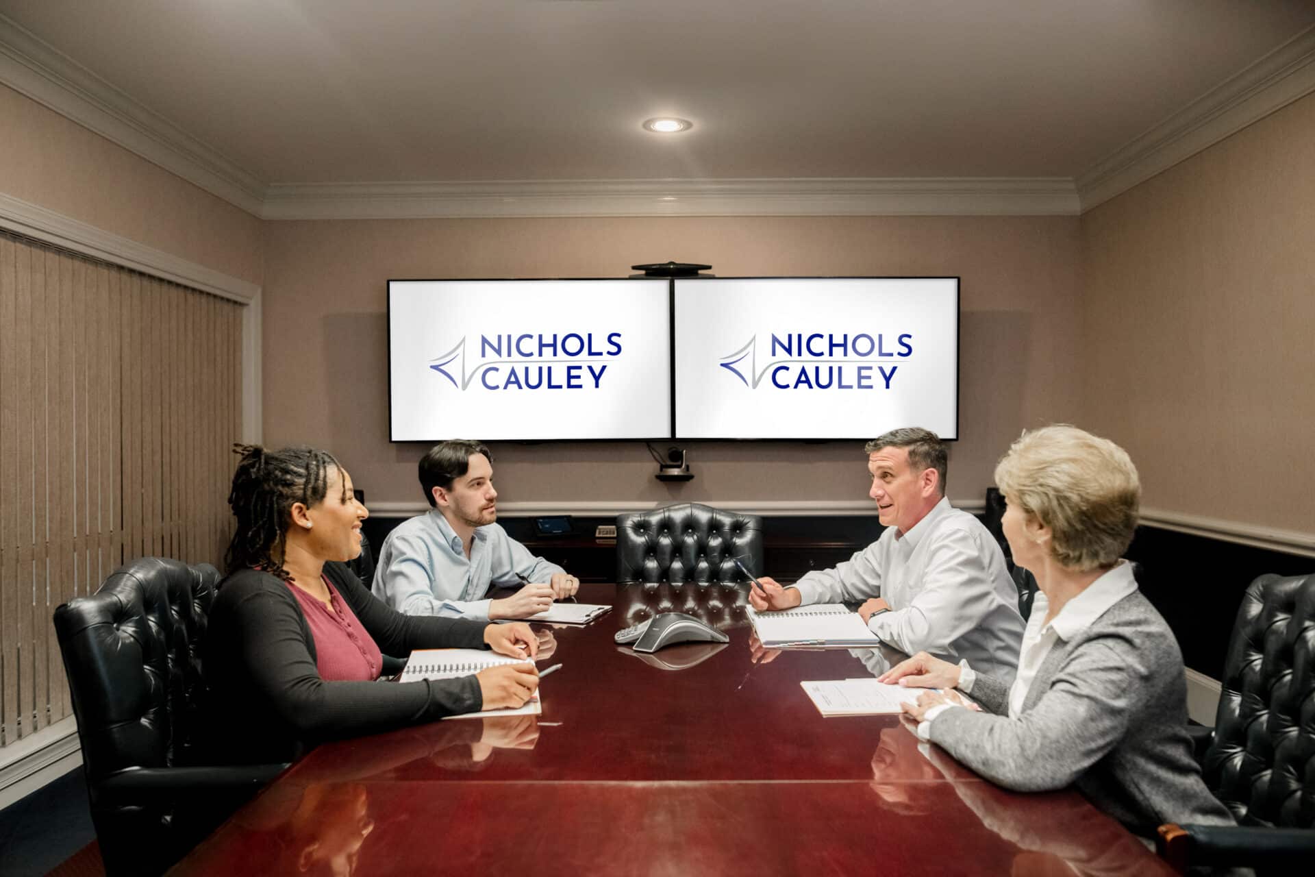 4 adults meeting in a conference room